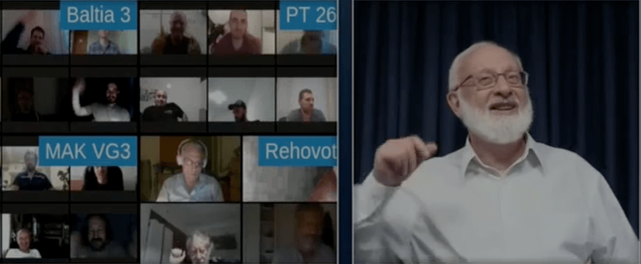 Michael Laitman speaking on camera during an online lesson with participants